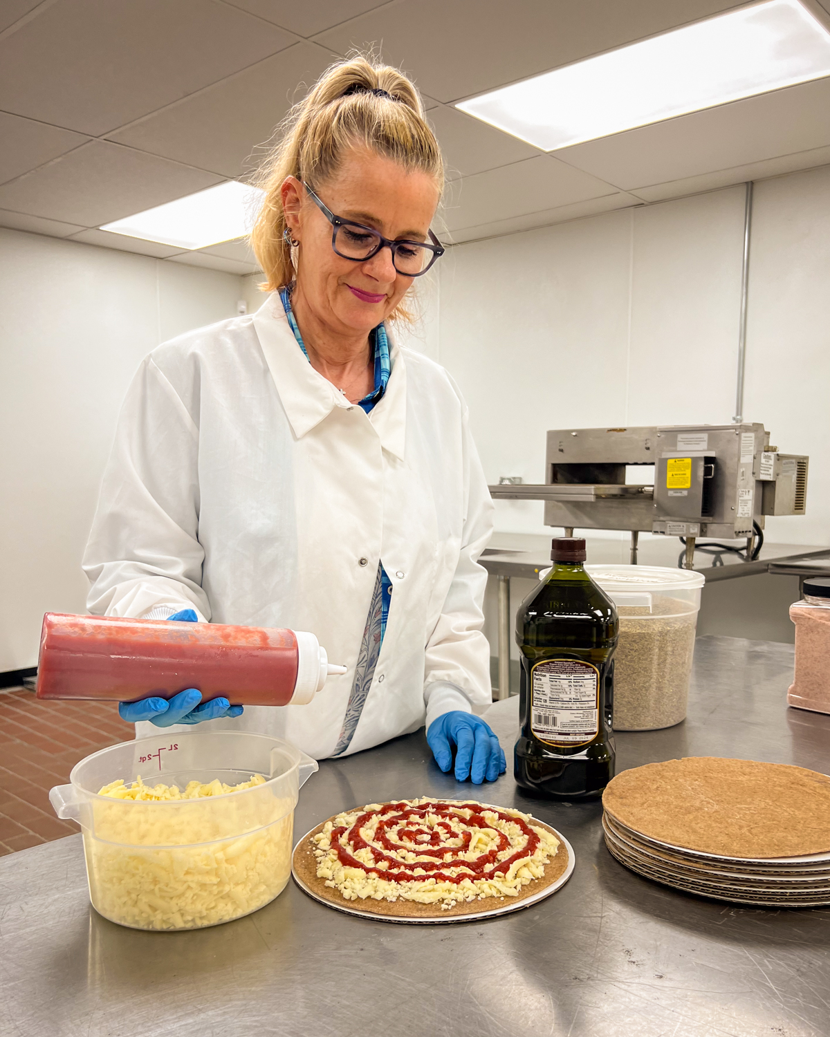 Picture of Tami in a lab coat in a clean room.